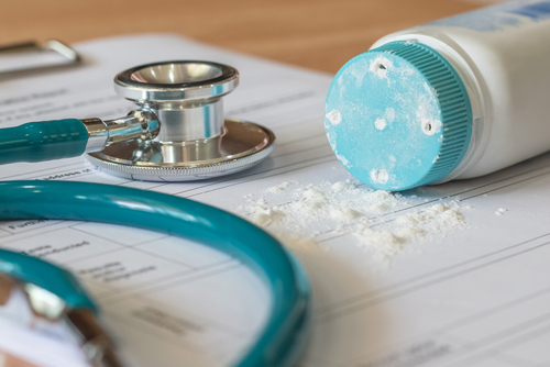 talcum powder spilled on a medical for and a stethoscope