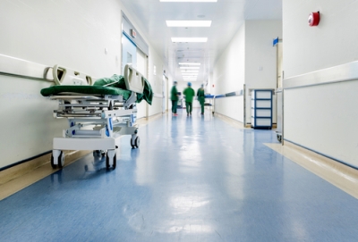 a hospital corridor with medical personnel walking down the hall
