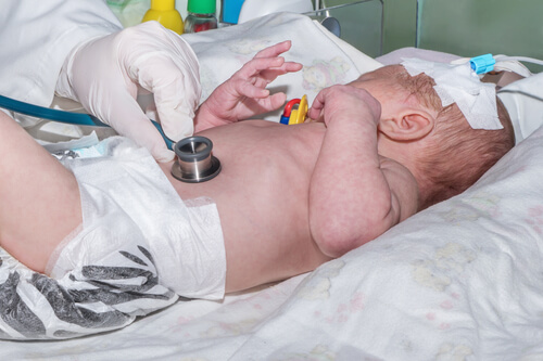 newborn laying in the hospital