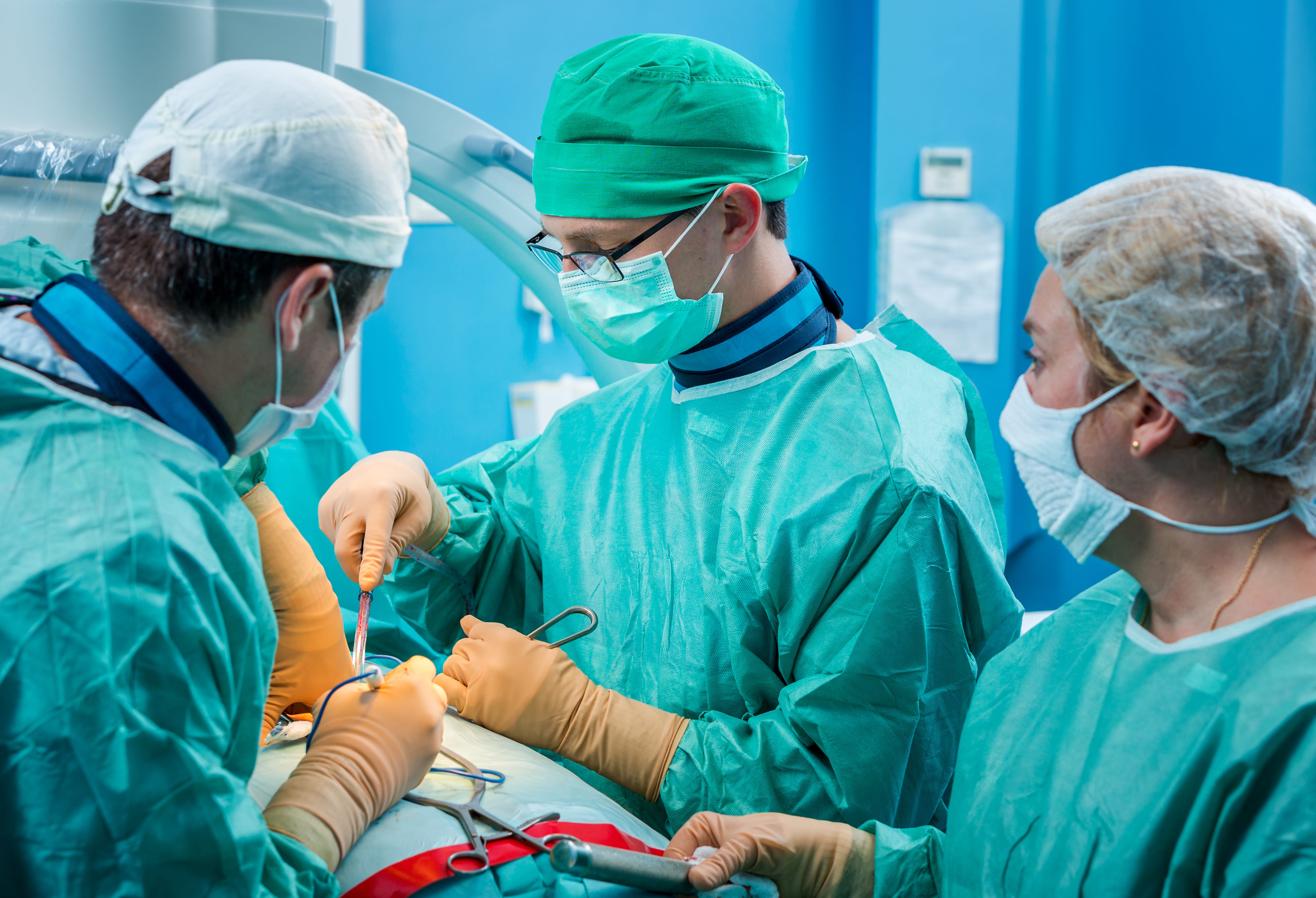 Orthopedic surgeons performing knee operation.