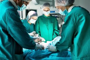 A surgical team working in an operating room makes a surgical error.