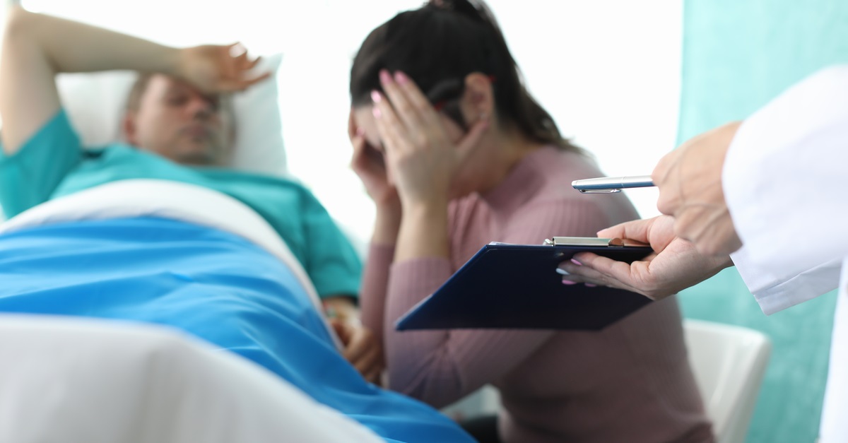 A woman learning her husband has suffered due to medical malpractice in Rockville, MD.
