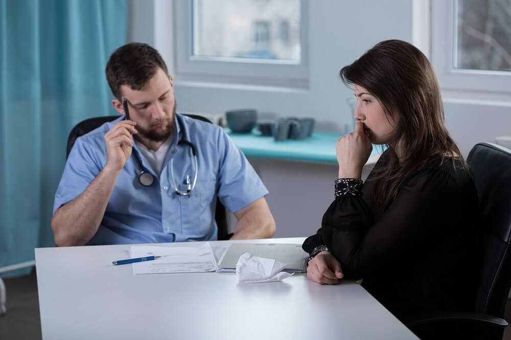 Patient's spouse talking to doctor.