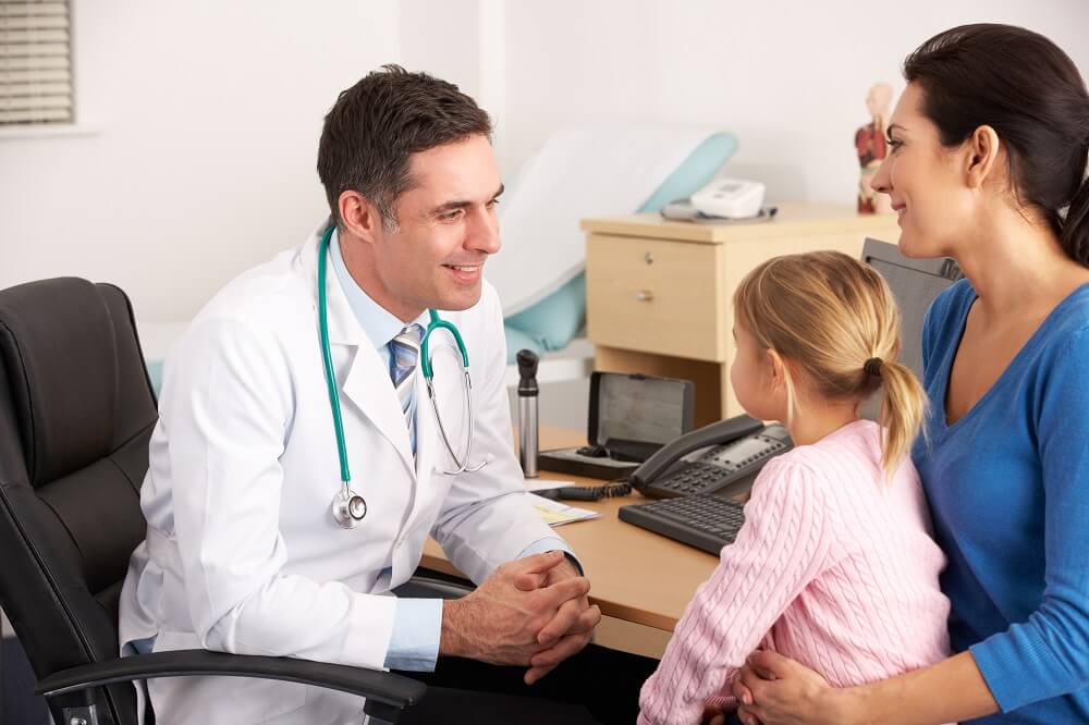 Pediatrician checking girl's health condition.