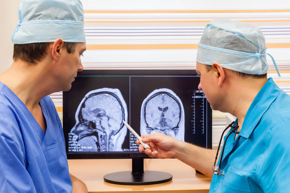 Doctors discussing brain scan results of patient.