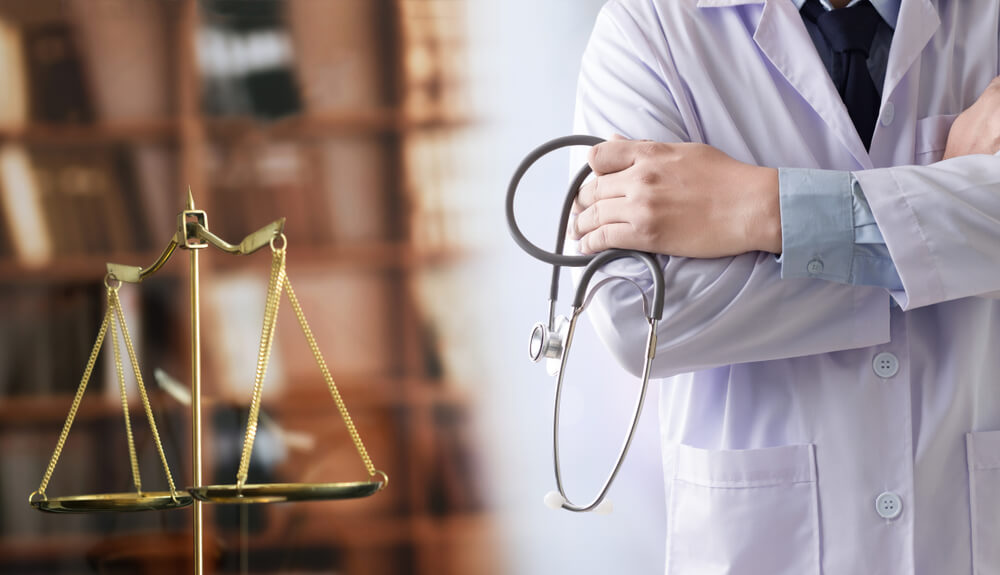 Medical malpractice concept with doctor holding stethoscope on the side