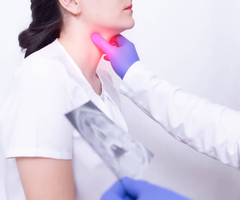 A specialist doctor diagnoses a girl s sore throat by palpating for the presence of inflammation and swelling, sore throat and tonsillitis of the throat