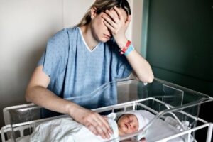 Mother is sad of her baby with birth injuries.