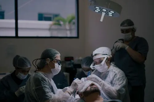 Surgeons performing surgery on man