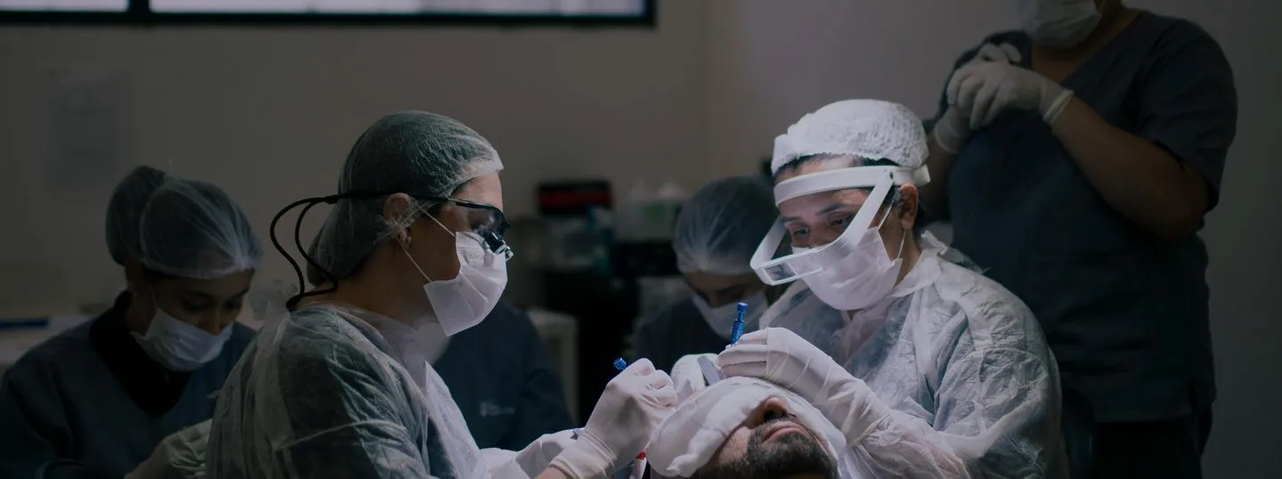 Surgeons performing surgery on man