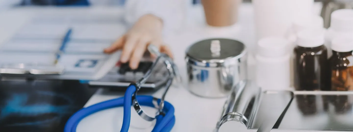 Doctor reaching for her gear and calculator