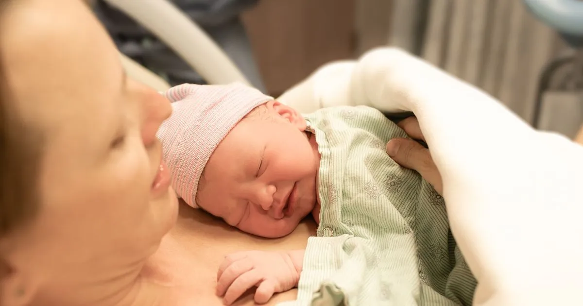 new born baby being held by mother